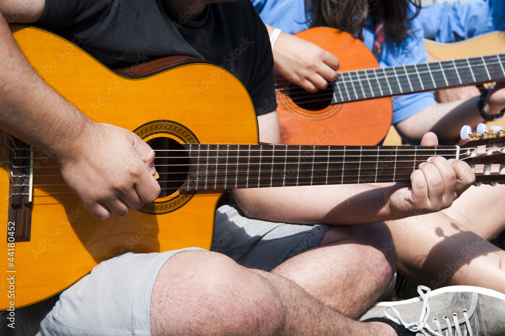 young people playing guitar together