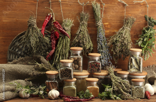 dried herbs, spices and and pepper, on wooden background © Africa Studio