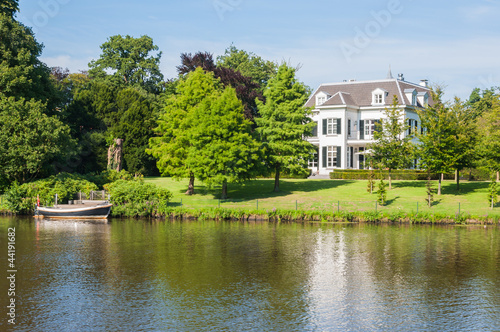 Large white villa on a waterside