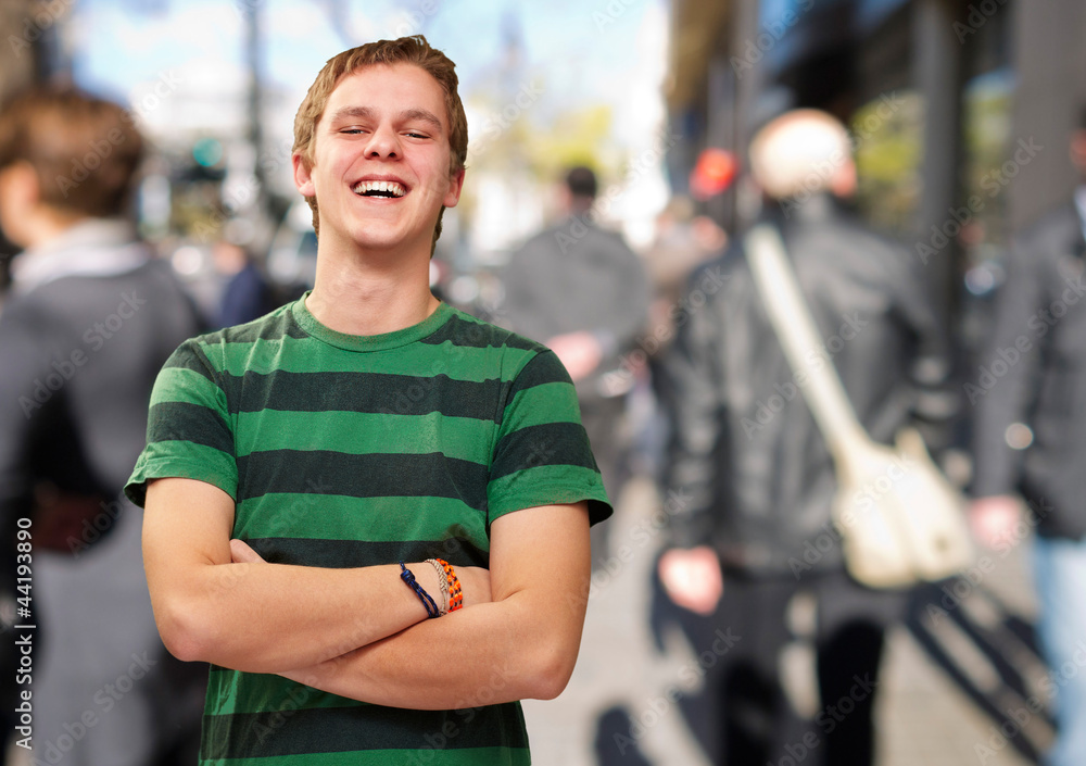 portrait of young man smiling at city