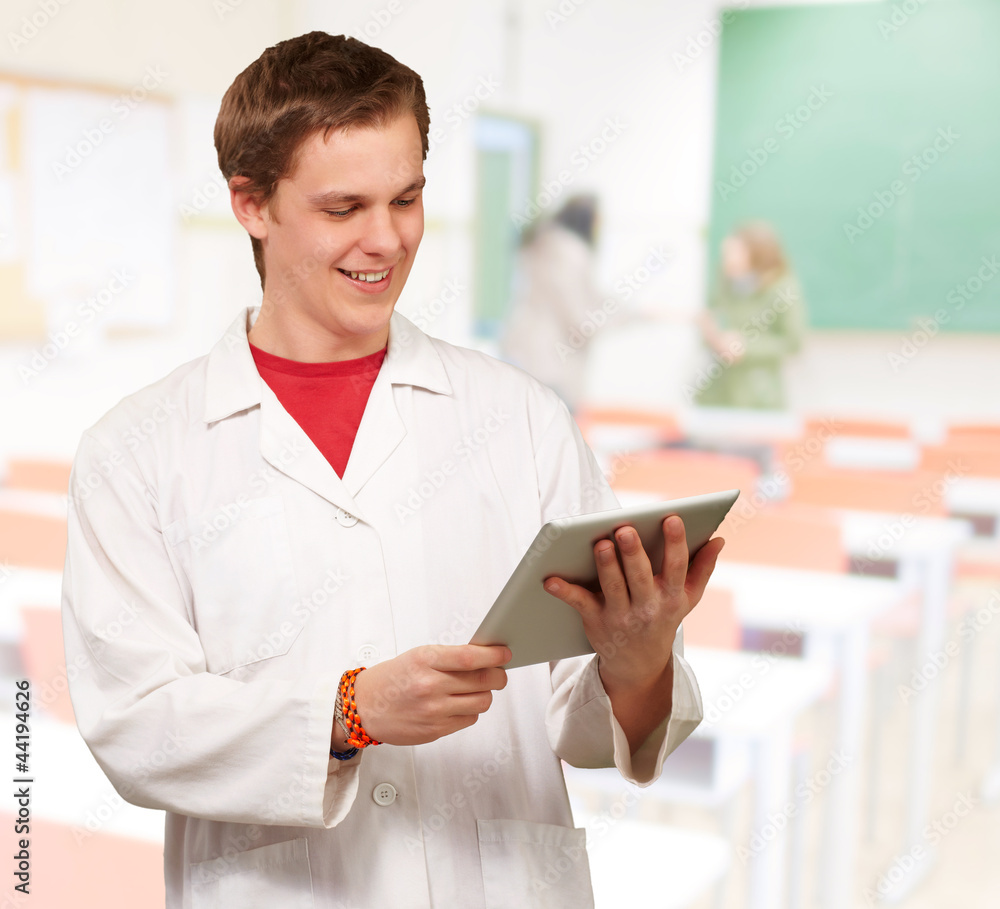 portrait of young academic holding a digital tablet at classroom portrait of young academic holding a digital tablet at classroom
