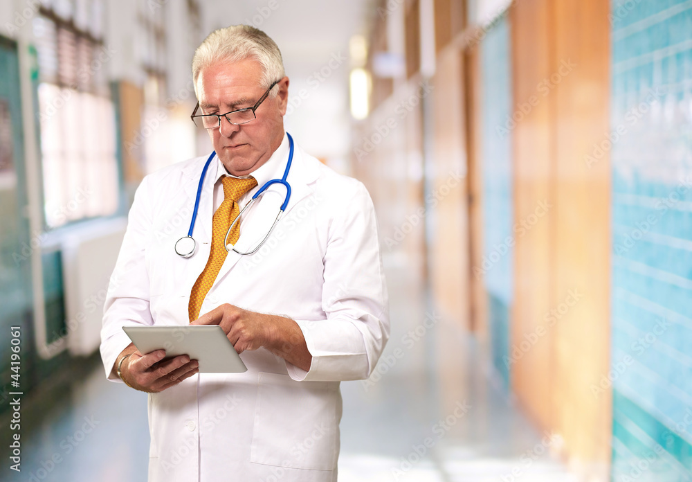 Portrait Of A Male Doctor Holding A Tab Portrait Of A Male Doctor Holding A Tab