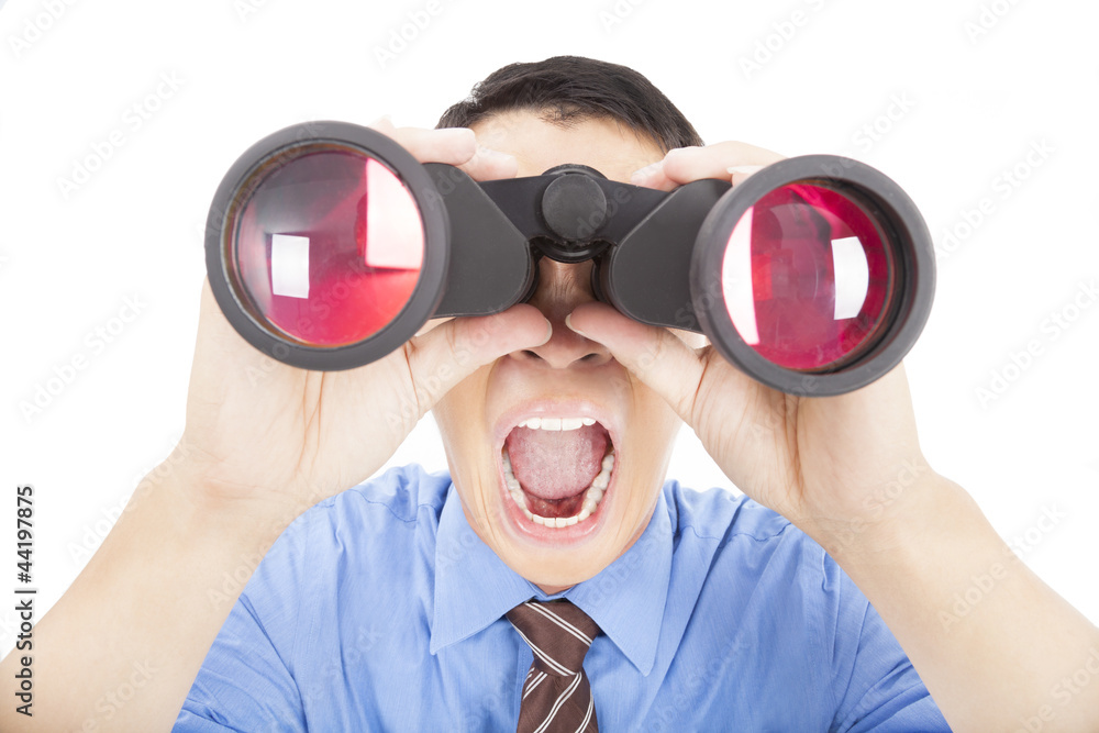 surprised businessman looks through binoculars and isolated surprised businessman looks through binoculars and isolated