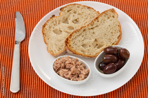 bread with tuna and olives on the plate