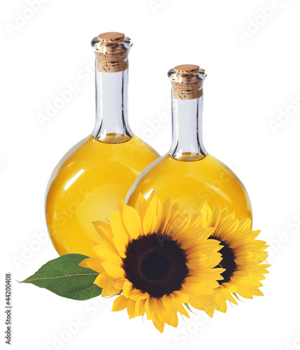 oil in bottles and sunflowers, isolated on white