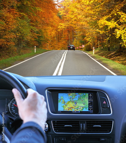 Travel by car with gps in autumnal scenery