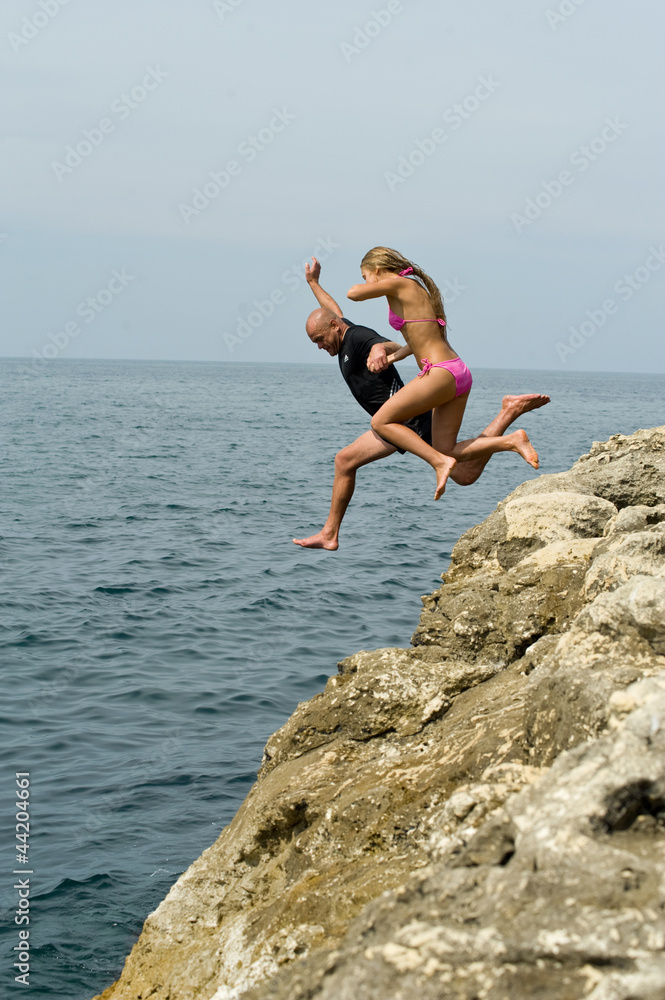 people jump off a cliff