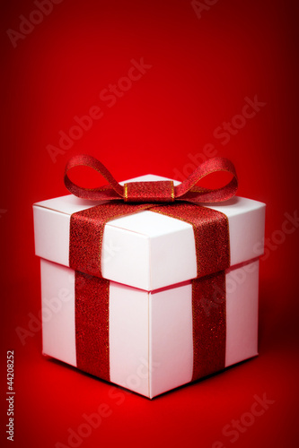 gift box with red ribbon on a red background