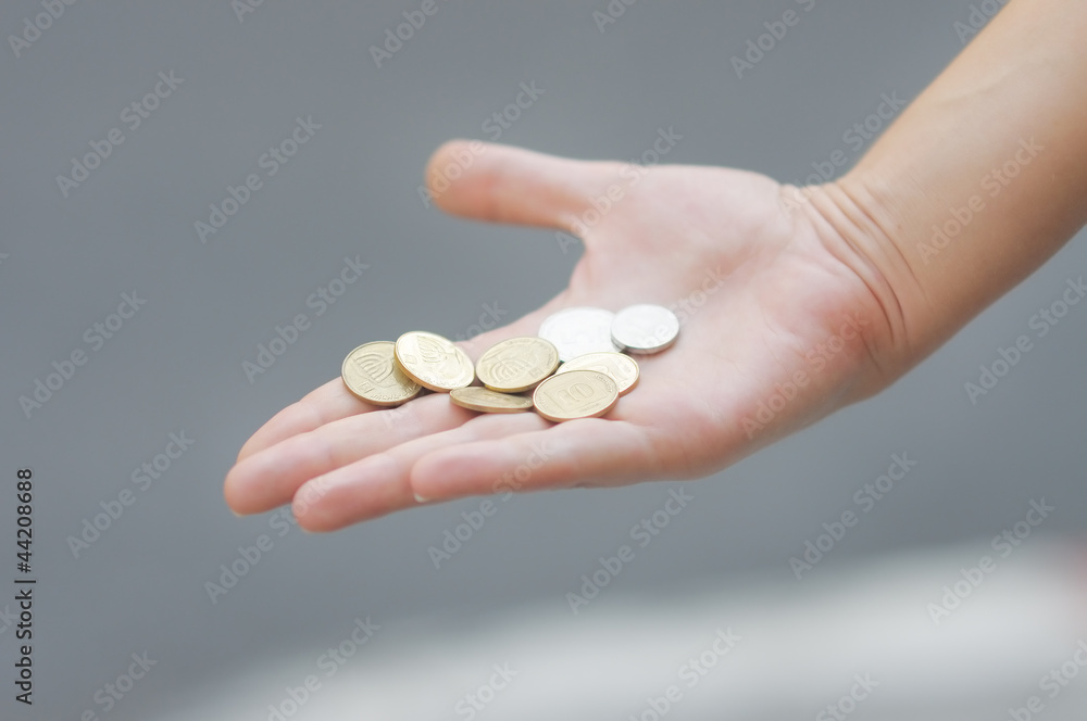 Woman holding golden and silvery coins (shekels) in her hand Woman holding golden and silvery coins (shekels) in her hand