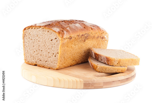 rye bread on wooden plate isolated on white
