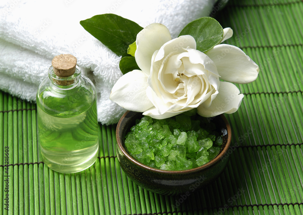 gardenia flower with towel with essential oil on green mat gardenia flower with towel with essential oil on green mat