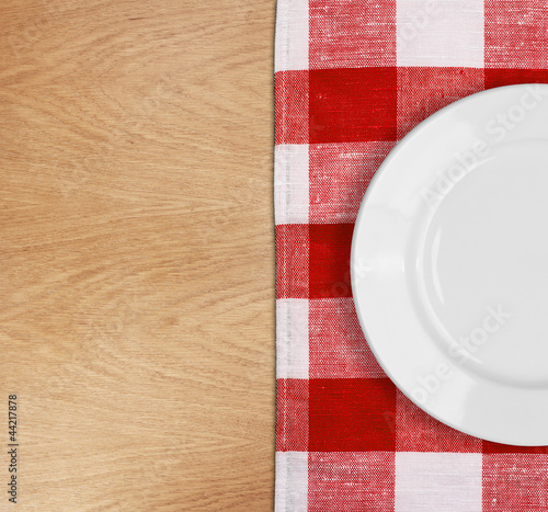 white plate on table with red checked tablecloth
