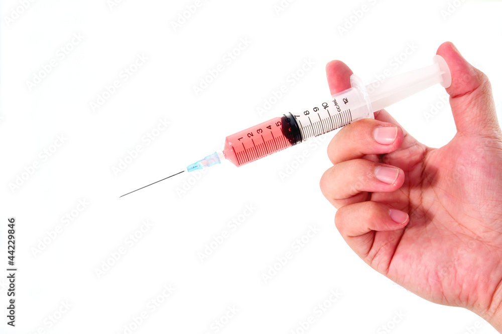 Hand holding filled hypodermic needle, isolated on a white backg Hand holding filled hypodermic needle, isolated on a white backg