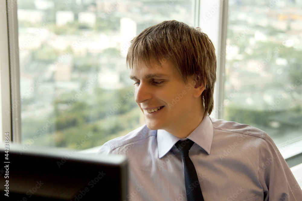 Businessman working on computer at office desk Businessman working on computer at office desk