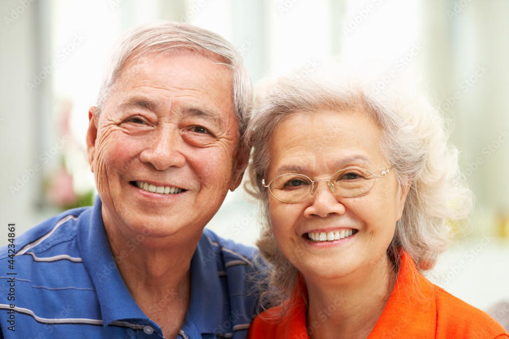 Senior Chinese Couple Relaxing On Sofa At Home Senior Chinese Couple Relaxing On Sofa At Home