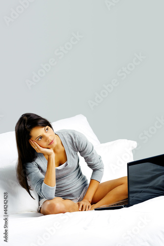 laptop bed woman happy