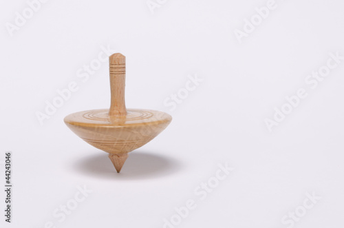 Little spinning top spinning on white background photo