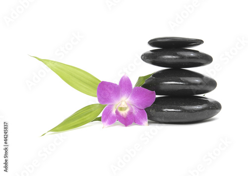 Zen pebbles balance. Orchid and bamboo leaf