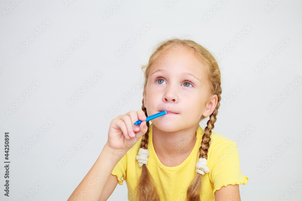 Little girl raising finger in funny attention gesture isolated Little girl raising finger in funny attention gesture isolated