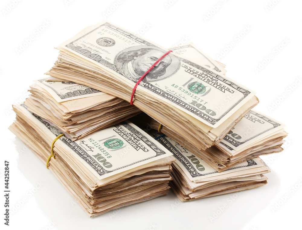 Stacks of one hundred dollars banknotes close-up isolated Stacks of one hundred dollars banknotes close-up isolated