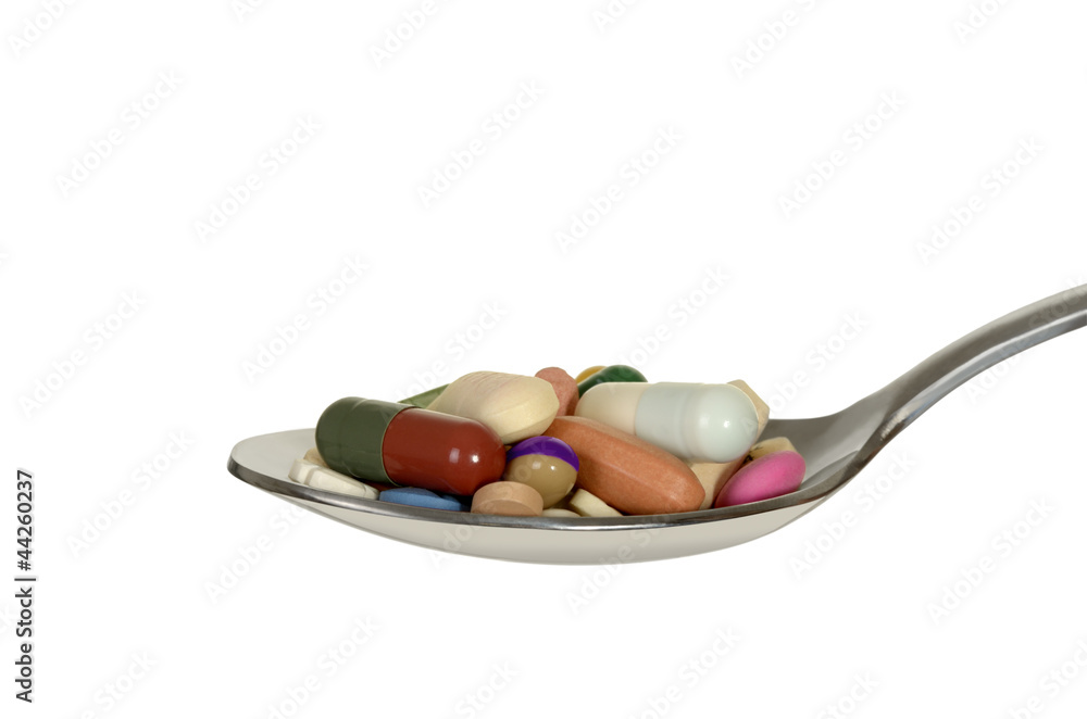 Löffel mit verschiedenen bunten Tabletten Löffel mit verschiedenen bunten Tabletten