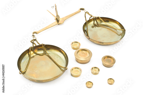 Thrown golden balance scales with weights