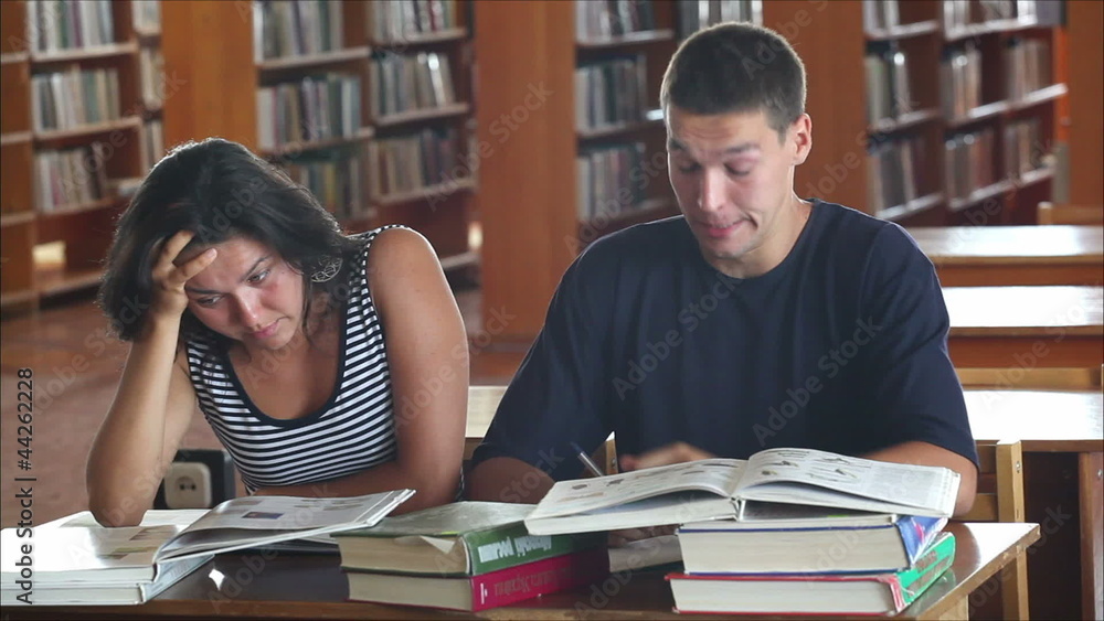 tired students in the library reading books 3 tired students in the library reading books 3