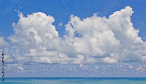 white fluffy clouds and sea