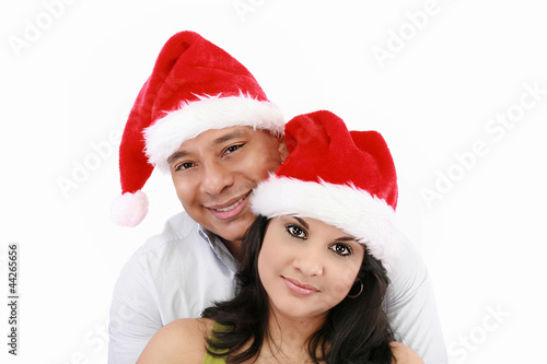 Young couple at Christmas with Santa Claus hats