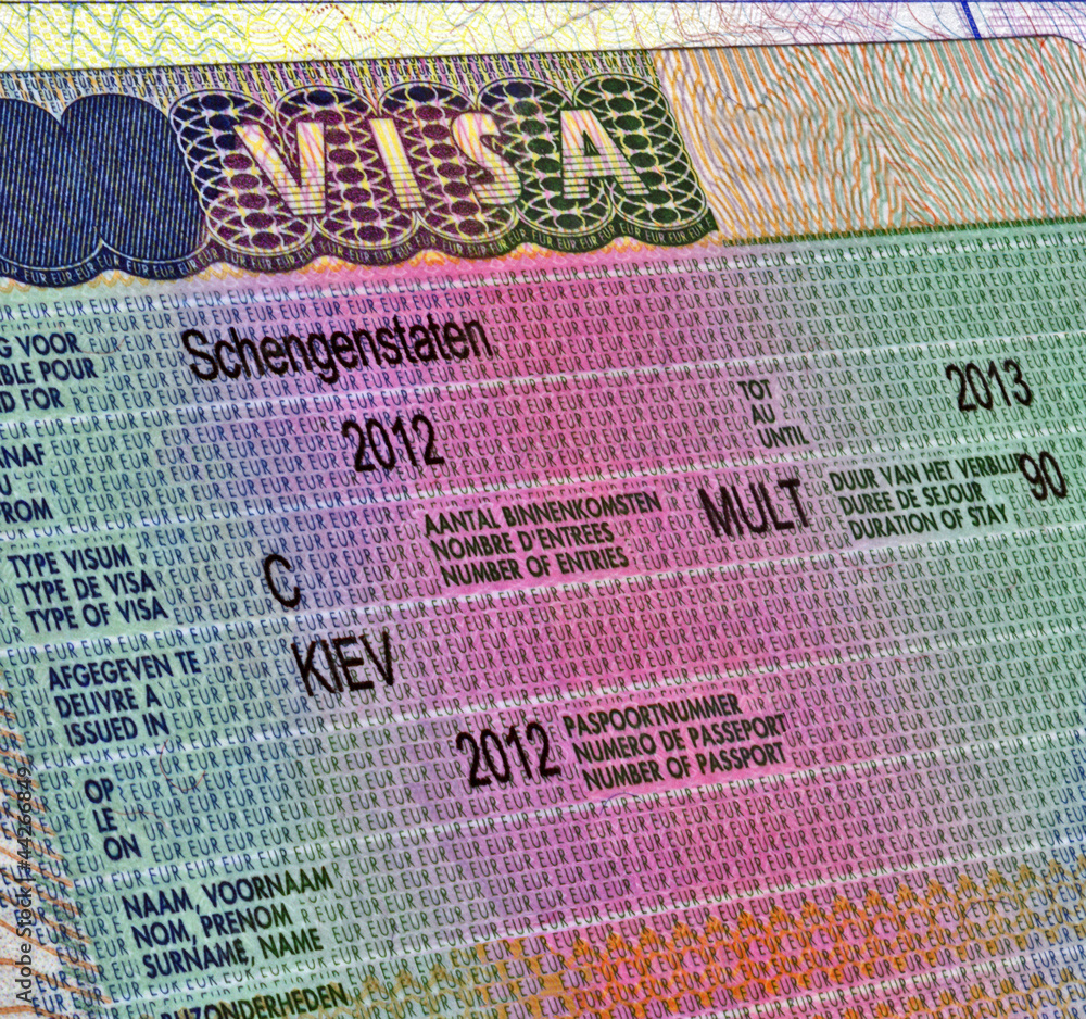 Obraz premium Schengen visa in passport for ukrainian citizen, business travel document, legal work emmigration, Europe tourism diversity 