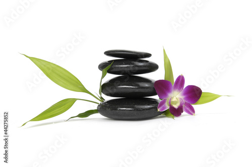 Pink orchid and bamboo leaf with stacked stones