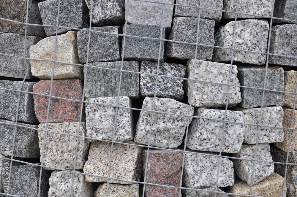 Stone paving stones of granite in a steel container Stone paving stones of granite in a steel container