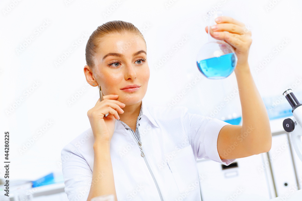 Young female scientist working in laboratory Young female scientist working in laboratory