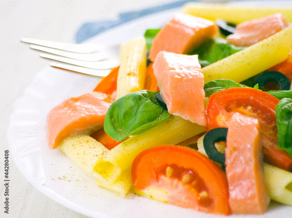 Pasta salad with tomatoes, basil leaves and fish Pasta salad with tomatoes, basil leaves and fish