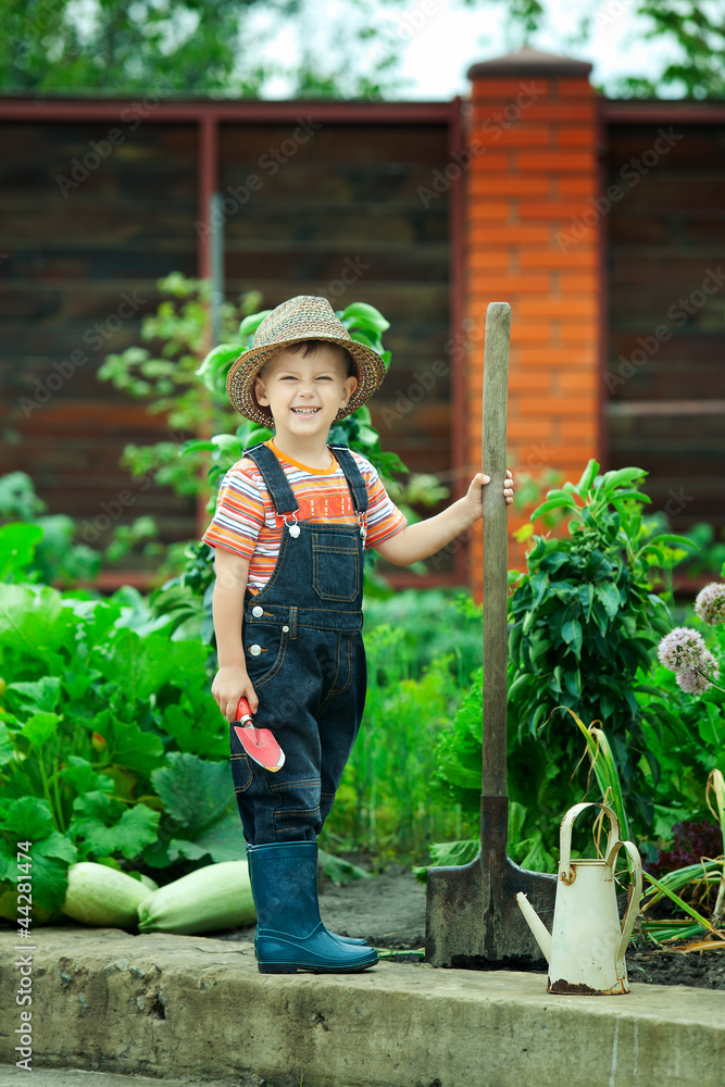 Portrait of a boy working in the garden in holiday