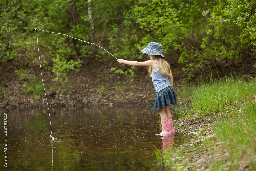 Little girl are fishing on lake in forest Little girl are fishing on lake in forest