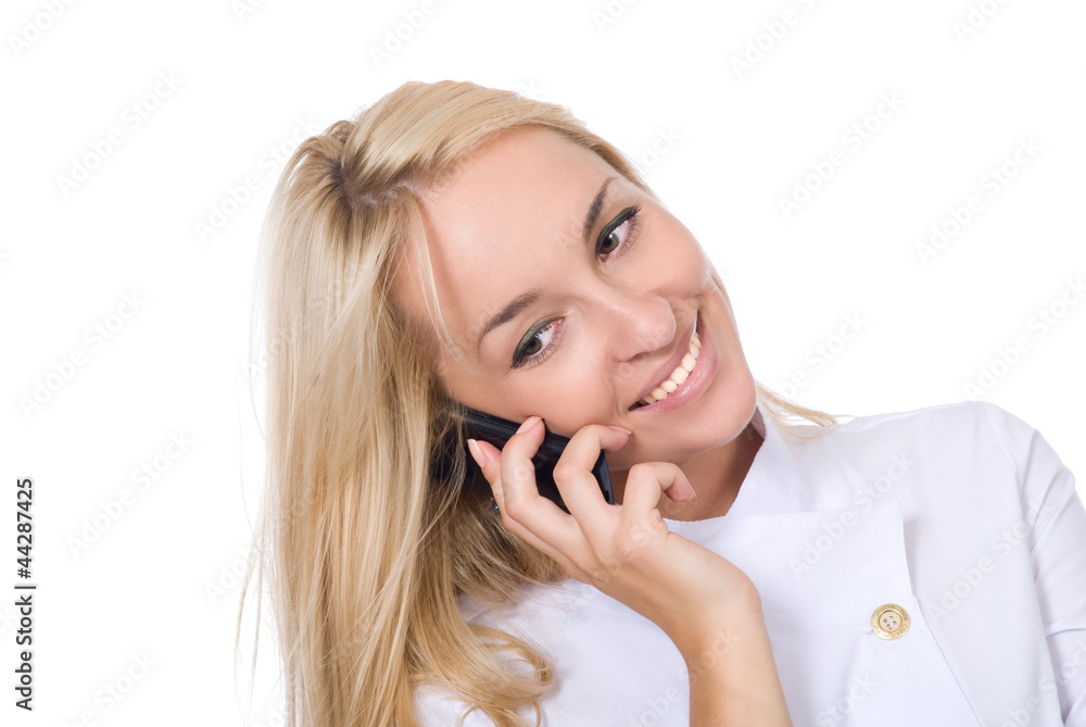 Young smiling beautiful doctor talks by mobile phone Young smiling beautiful doctor talks by mobile phone