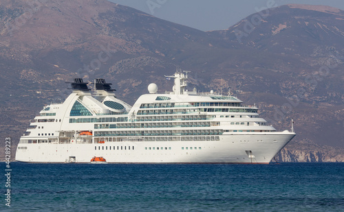Luxury cruise ship anchored of the coast of a Greek island © Lefteris Papaulakis