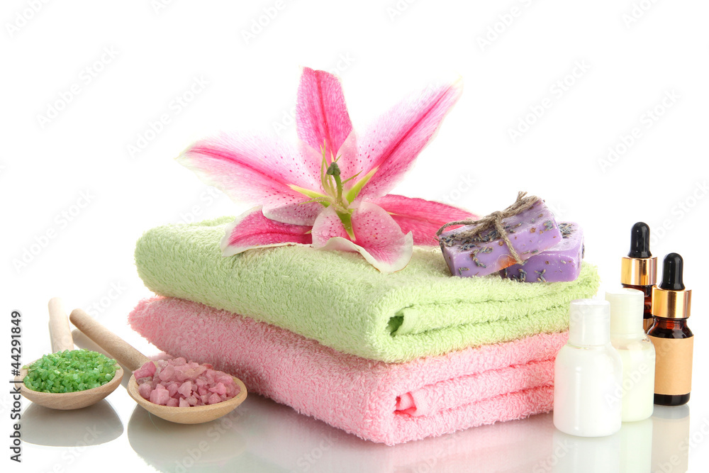 towels with lily, aroma oil, soap and sea salt isolated on towels with lily, aroma oil, soap and sea salt isolated on