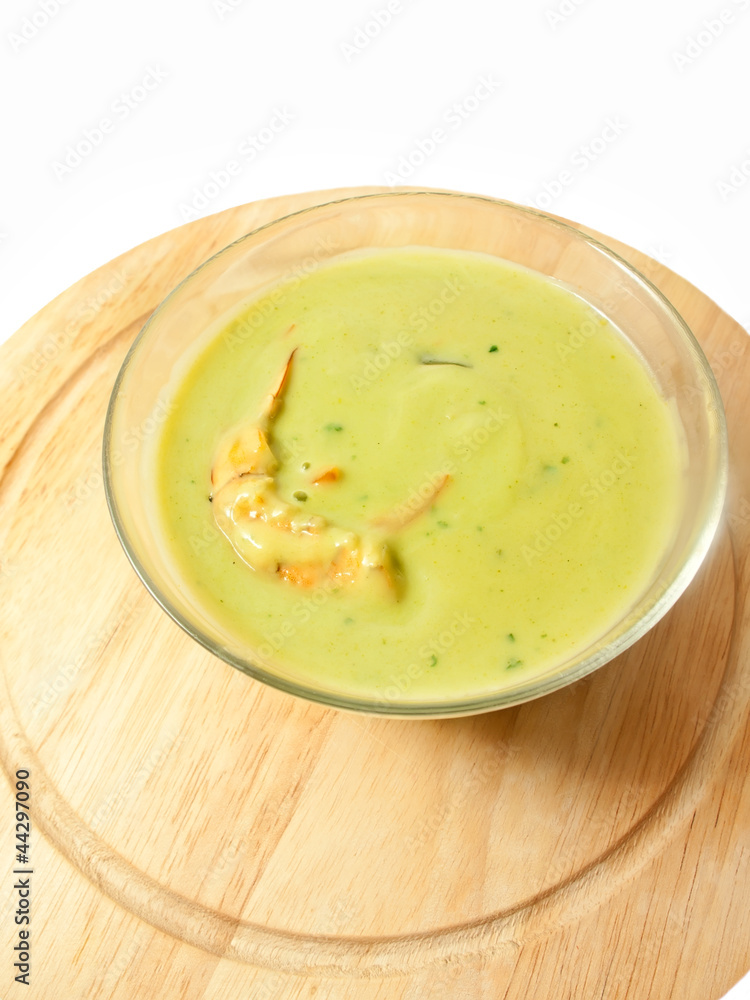 spinach cream soup with shrimp on the desk over white spinach cream soup with shrimp on the desk over white