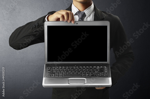 business man holding laptop