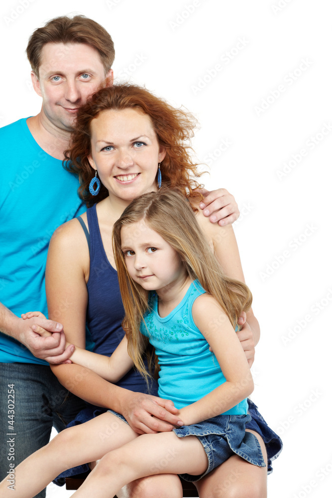 Family of three, father stands behind sitting mother Family of three, father stands behind sitting mother