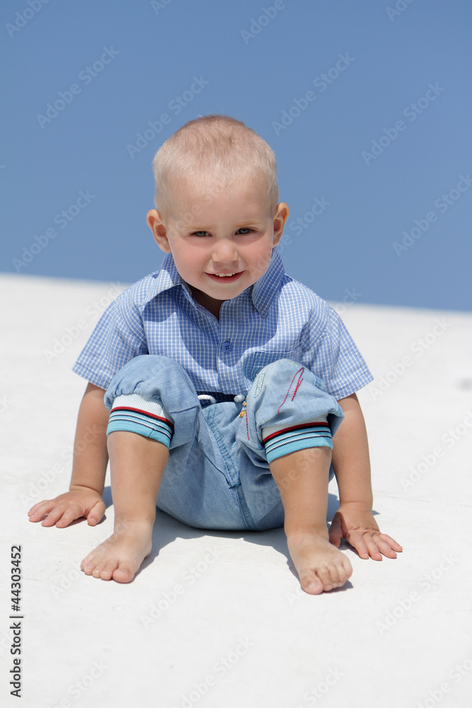 outdoor portrait of young happy smiling child isolated over blue outdoor portrait of young happy smiling child isolated over blue