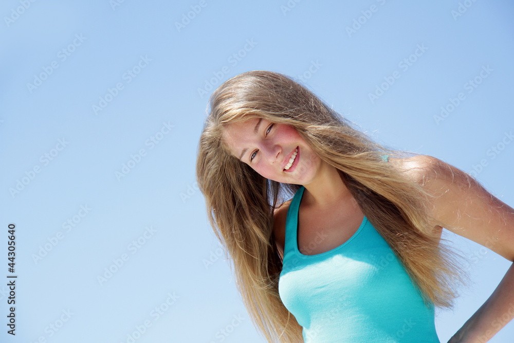 outdoor portrait of young attractive woman isolated over blue sk