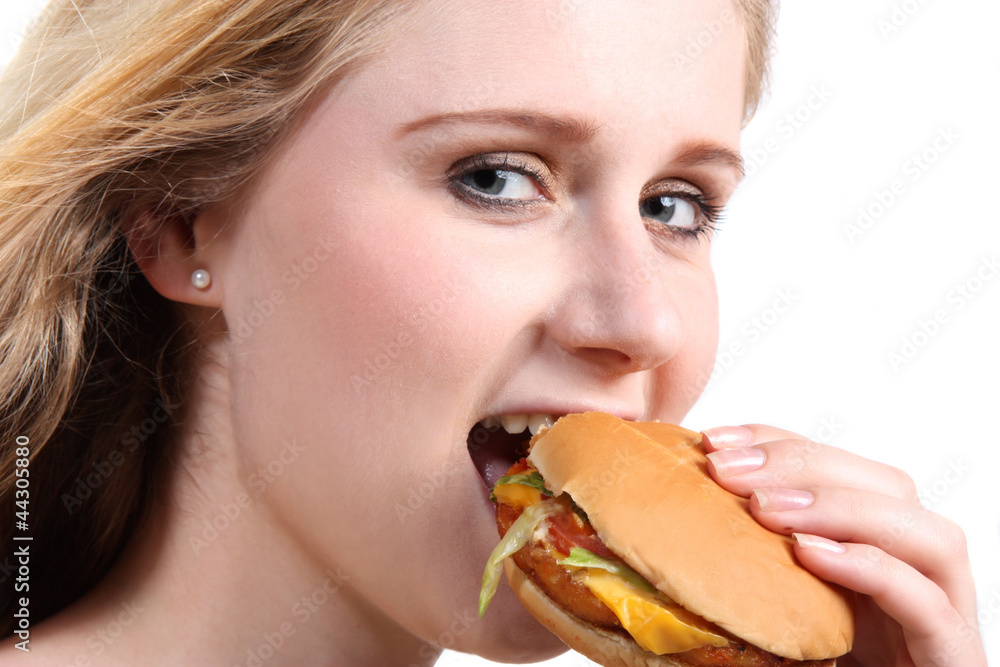Young woman eating vegetarian burger Young woman eating vegetarian burger