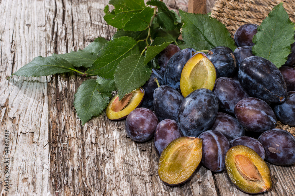 Fototapeta premium Basket with a heap of Plums