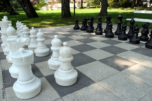 big chess set in the park with benches photo