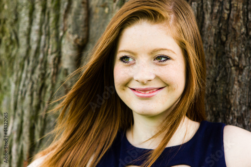 Smiling Girl in Front of Tree