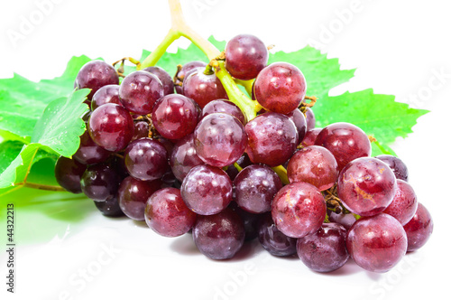Red grapes with fresh leaves, isolated on white background.