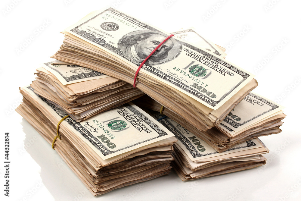 Stacks of one hundred dollars banknotes close-up isolated Stacks of one hundred dollars banknotes close-up isolated